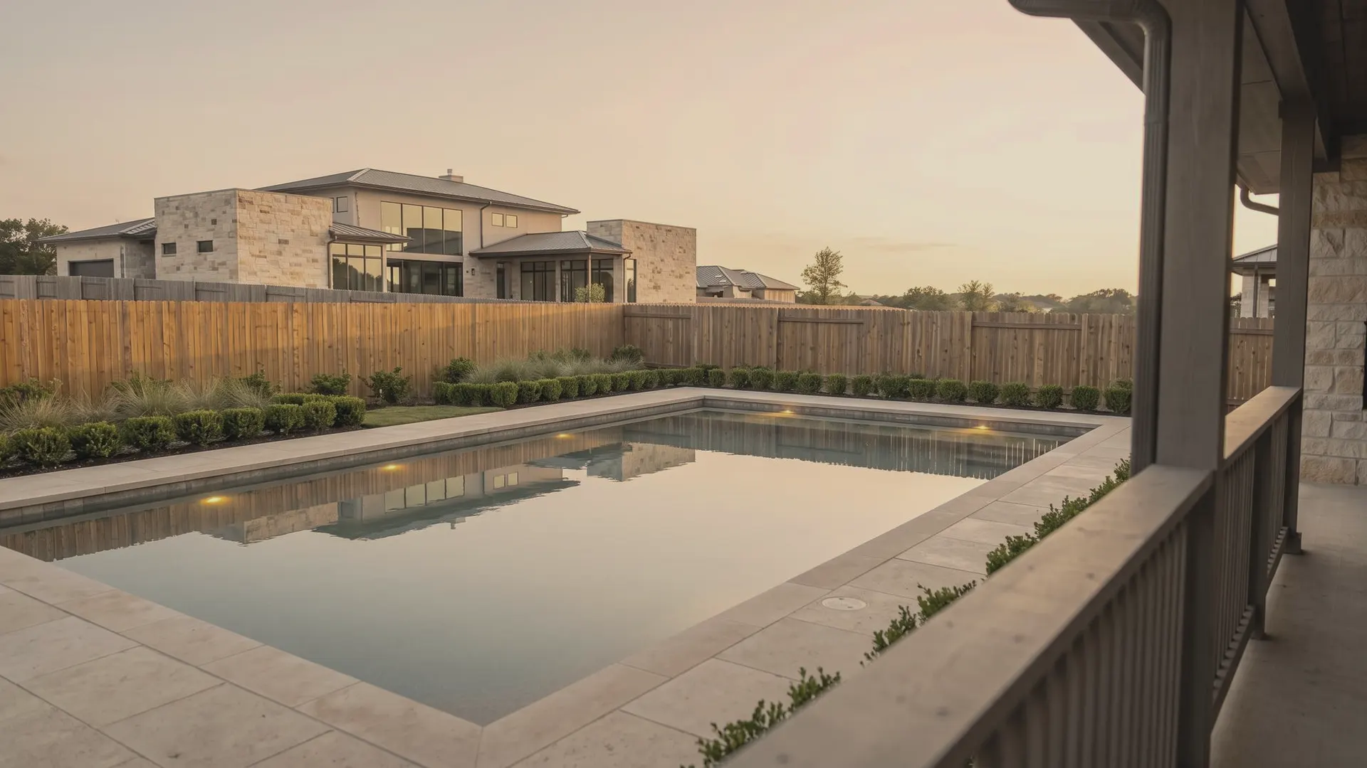 Concept-staged limestone pool edge and blue-hour water for the Stillwater Austin pool-builder showpiece.